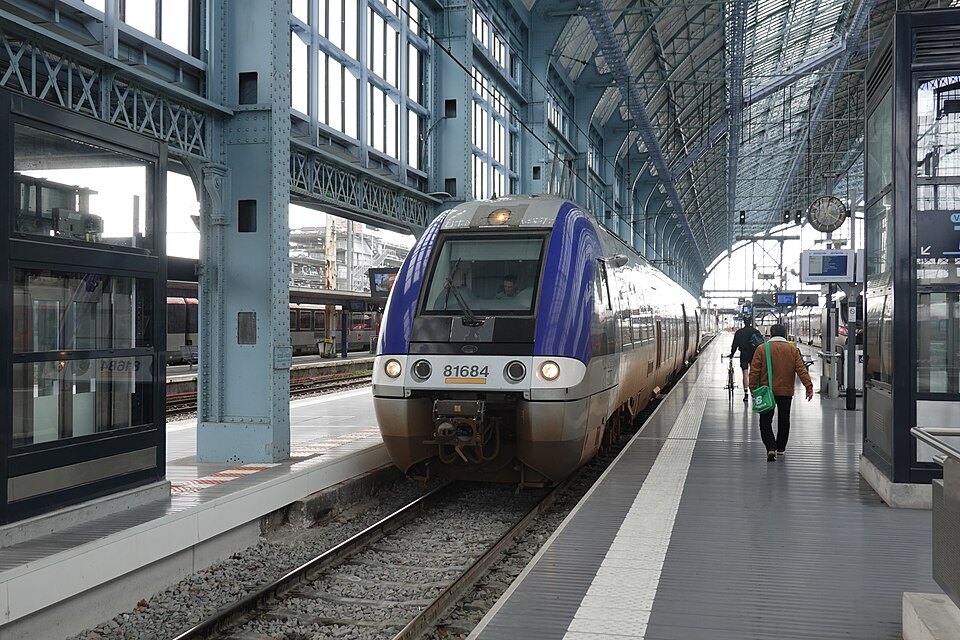 A regional train at a platform under the station roof