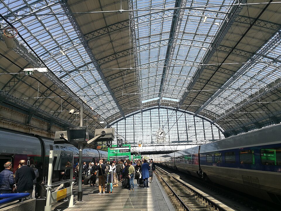 Travelers on a platform under the glass roof